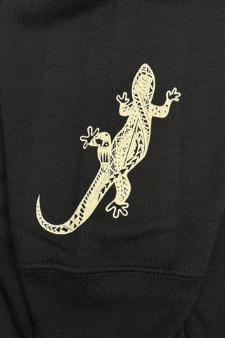 Close up of geometric gecko on sleeve of sweatshirt.