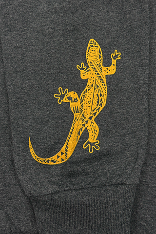 Close up of Mo' Betthas signature Gecko on sleeve of long sleeve charcoal gray tee.