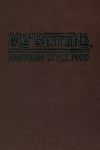 Close up of Mo' Bettahs Hawaiian Style Food logo, embroidered with black thread.