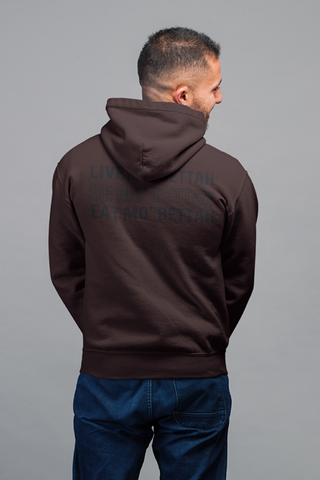 Showing back view of male model wearing chocolate brown hoodie , with Live, Be and Eat Mo' Bettah screen printed in black.