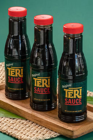 Mo' Bettahs Original Teri Sauce bottles on small wooden tray.