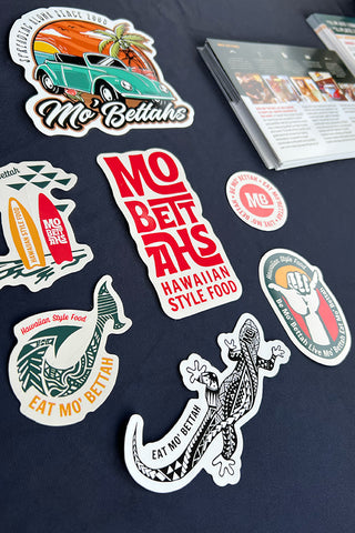 A collection of Mo' Bettahs stickers on dark blue background.
