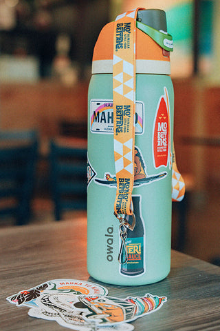 Water Bottle covered with Mo' Bettahs stickers and a lanyard draped over bottle.