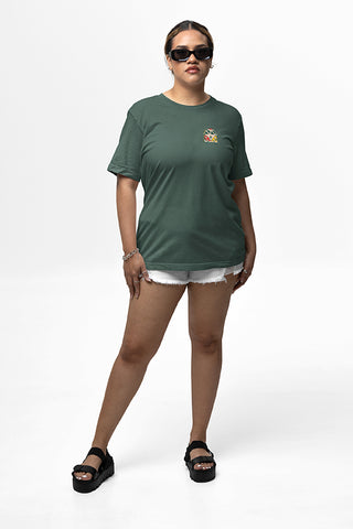 Woman wearing sun glasses and sage green T-Shirt with Mo' Bettahs VW bus logo on upper left breast.