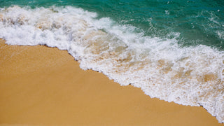 Beach scene with waves gently rolling in.